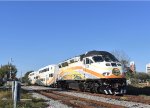 Sunrail Train # P313, being pushed by MP32PH-Q # 101, accelerates across the Ruby Ave Grade Crossing away from Downtown Kissimmee toward the last stop of Poinciana 